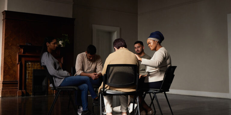 A group of people discussing the harm reduction model