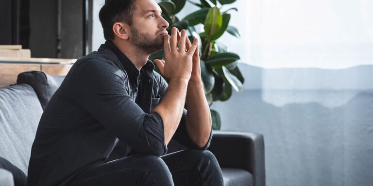 man in black looking up considers anxiety and addiction