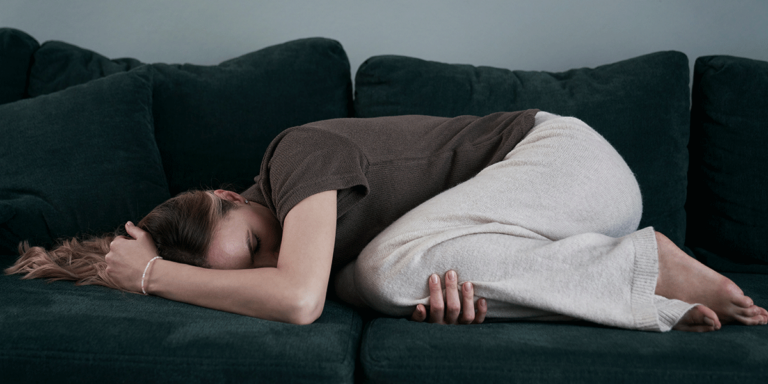 woman lying on couch working through the signs of meth withdrawal