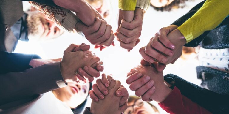 group of people holding hands