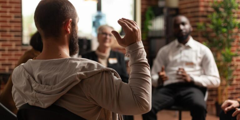 Person participating in group therapy in a drug rehab in Virginia Beach that accepts Medicaid