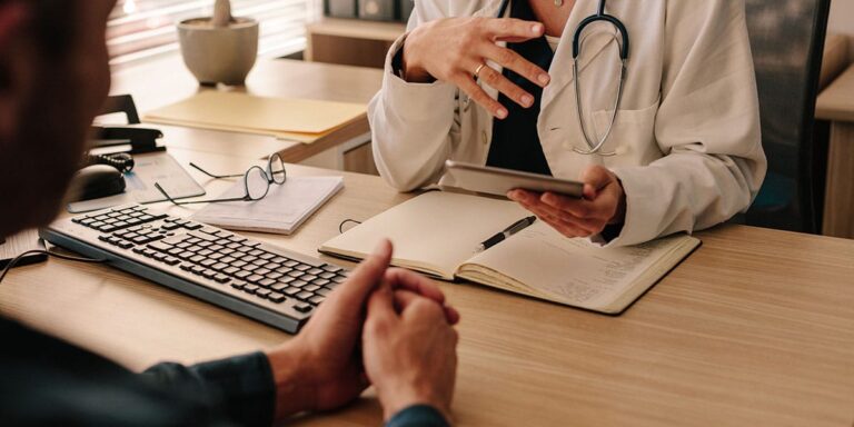 Intake nurse in a clinic office answering the question does medicaid cover vivitrol injections for a patient