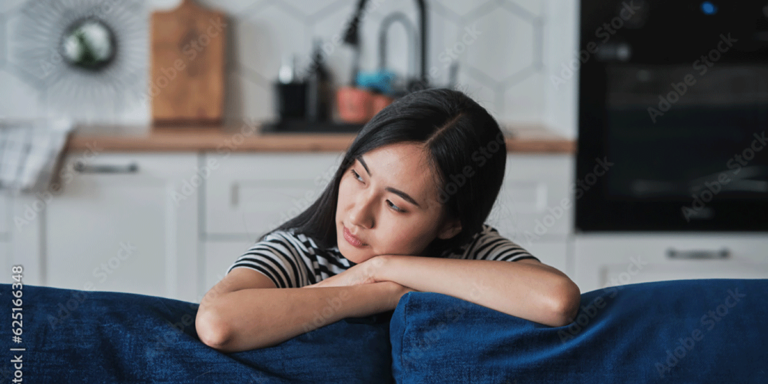 Person leaning against couch looking contemplating the facts and myths about addiction and withdrawal.