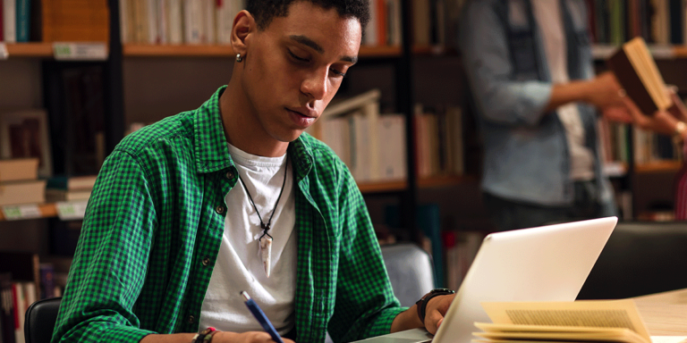 student in library researching answers to what is the effect of depression on students