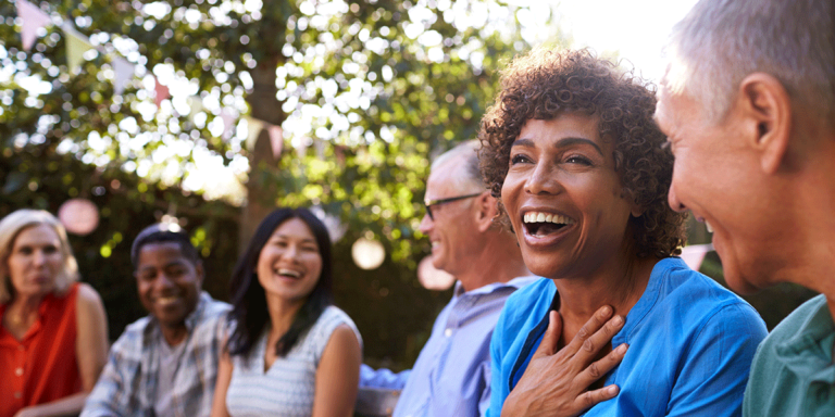 group of people having fun socializing outdoors while reaping benefits of an addiction relapse program