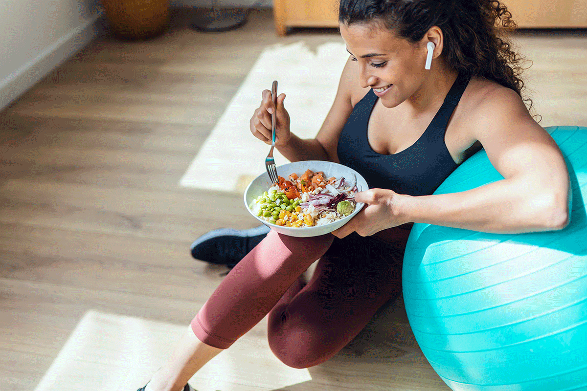 person in active wear eating salad while prioritizing nutrition and physical health during recovery