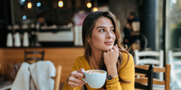 person sitting in coffee shop contemplating tips on preventing relapse