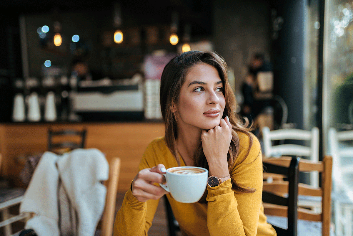 person sitting in coffee shop contemplating tips on preventing relapse