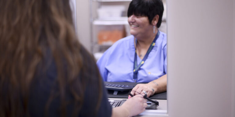 Nurse dispensing medication for medication assisted treatment.