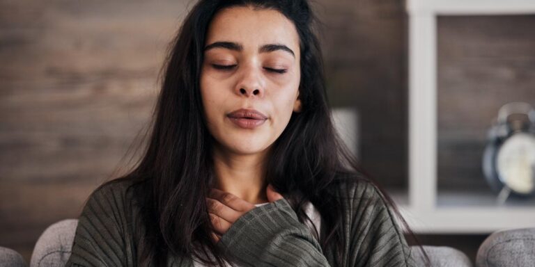 person doing breathing exercise while thinking about the warning signs of relapse