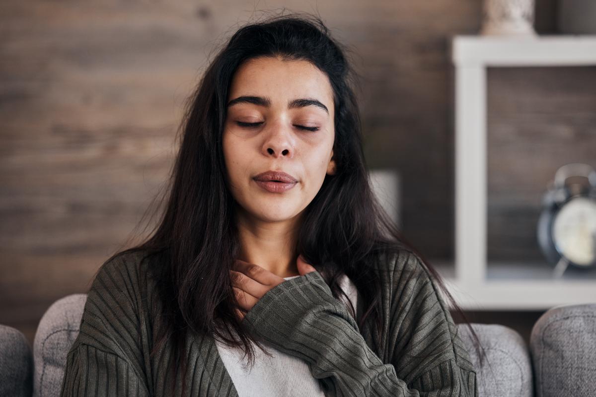 person doing breathing exercise while thinking about the warning signs of relapse