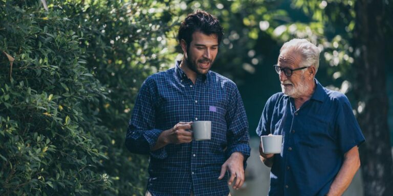 two people drinking coffee outdoors while discussing things to know about addiction in a loved one