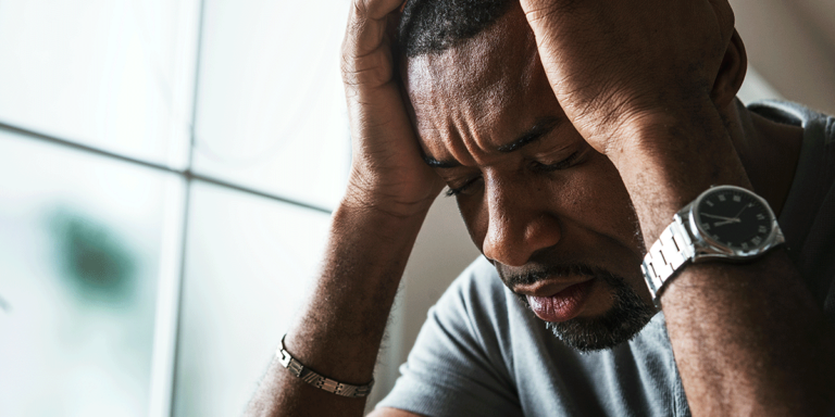 person hanging head while showing signs of addiction relapse