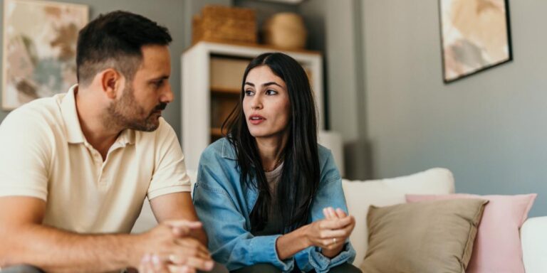 couple sitting on couch discussing warning signs of fentanyl abuse