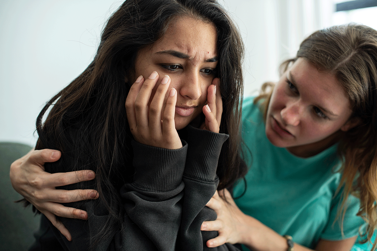 person helping loved one after recognizing signs of drug use in a friend